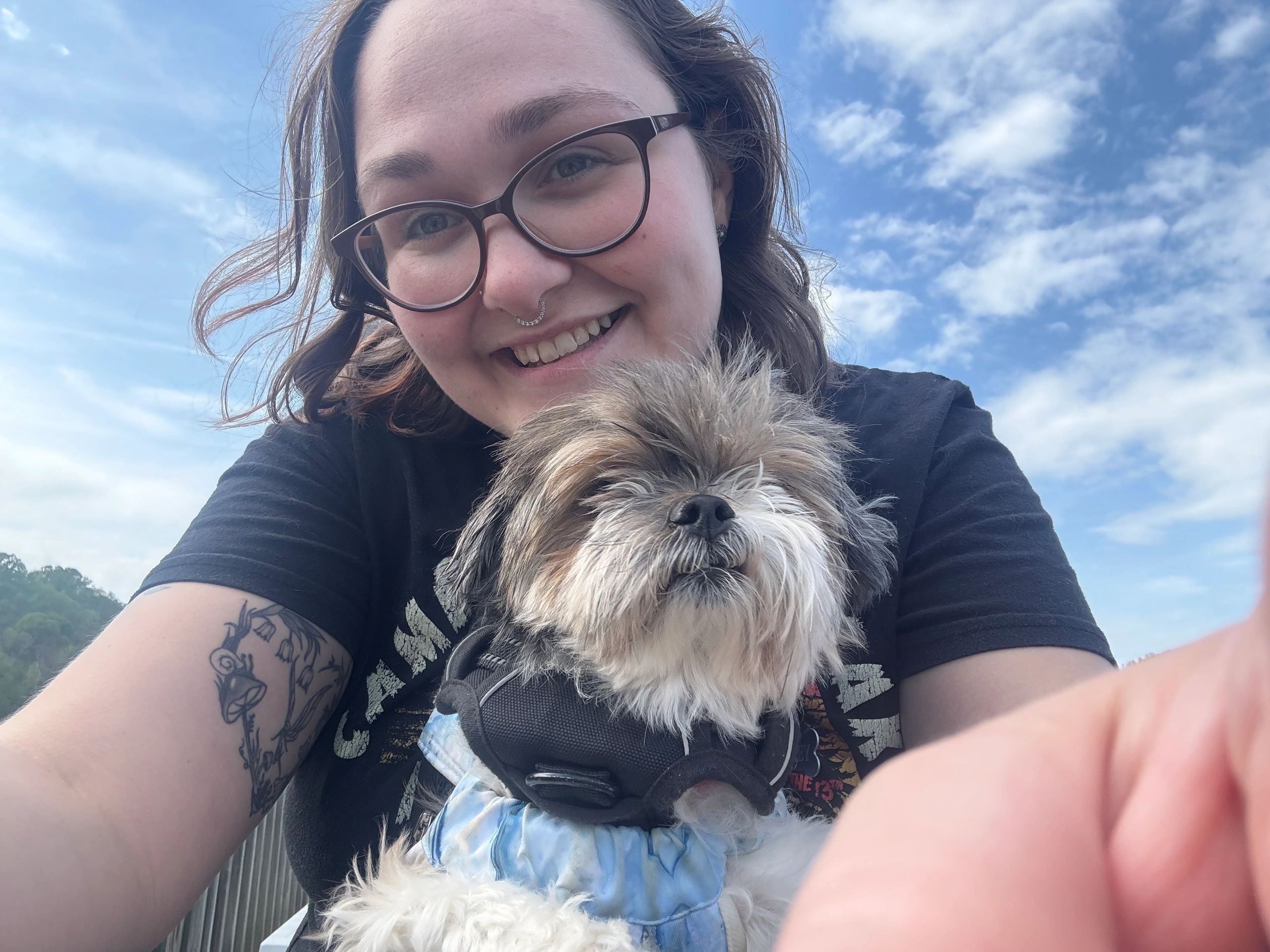 Owner of Say Yes to the Pets holding a small fluffy dog